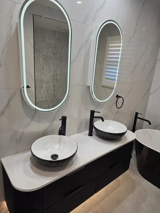 Twin black vessel basins on the double vanity