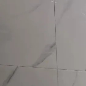 Calacatta marble-look porcelain wall tile, floor to ceiling