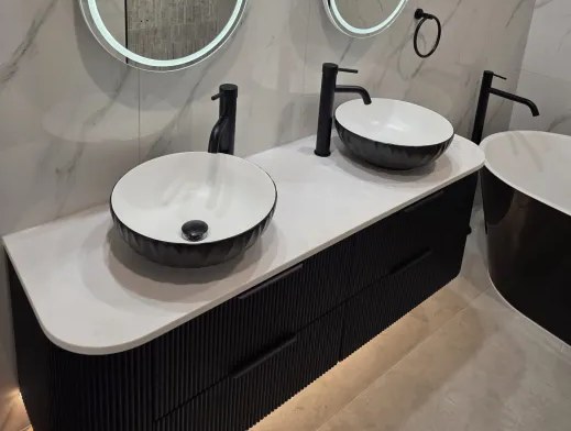 Fluted vanity drawer fronts and twin black basins detail