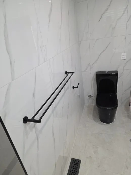 Matte black towel rail, flush button and accessories