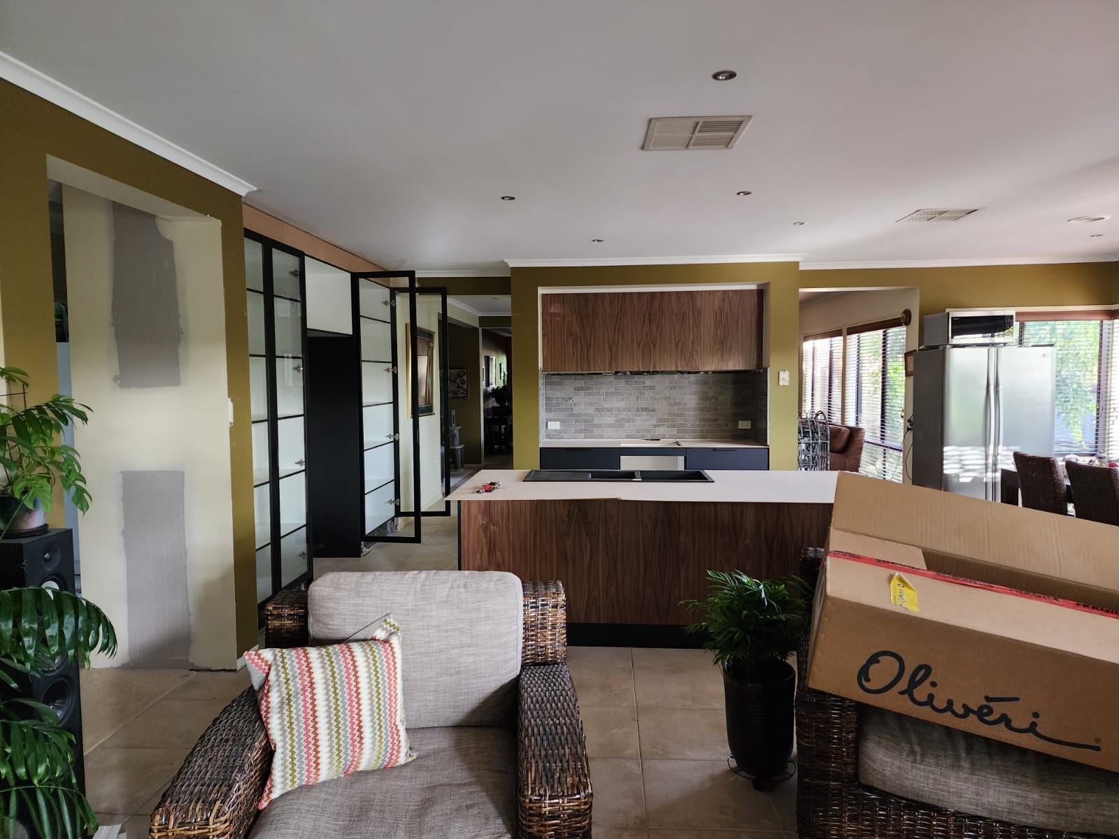 Wide shot of the finished kitchen with display unit and cabinetry